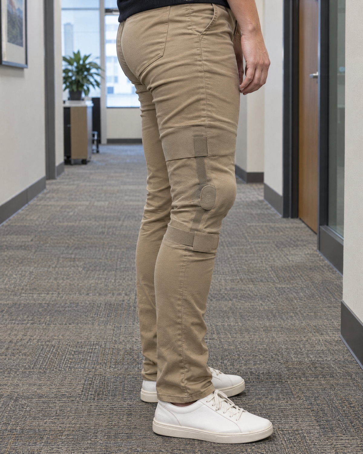 A knee brace bulging through pants